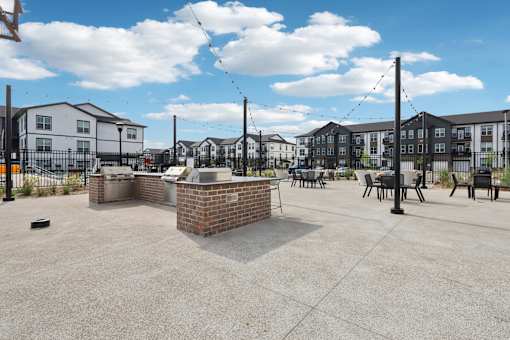 Outdoor grilling and seating area at Nook Nine community