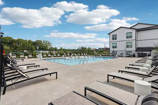 Swimming pool with lounge chairs at Nook Nine Apartments