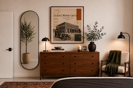 Modern bedroom with wood dresser and artwork at Cole Motor Apartments, Indiana