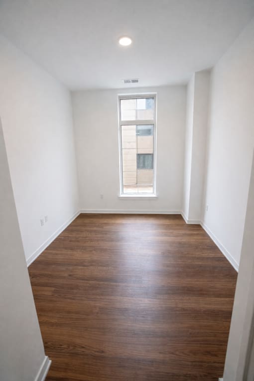 A room with wooden floors and a window.