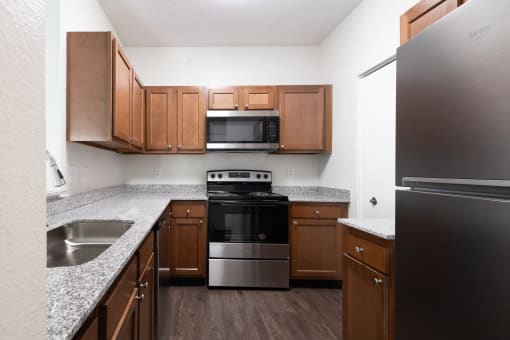 Kitchen with wooden cabinets at Altitude at Blue Ash, Blue Ash, 45242