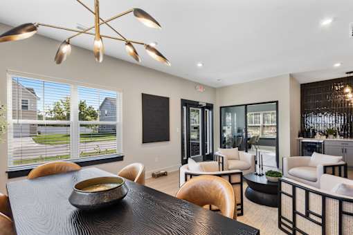 A modern dining room with a black table and chairs.