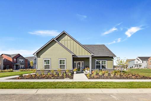 A house with a grey front yard and a grey roof.
