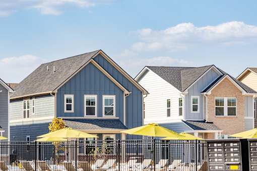 A row of houses with yellow umbrellas in front.