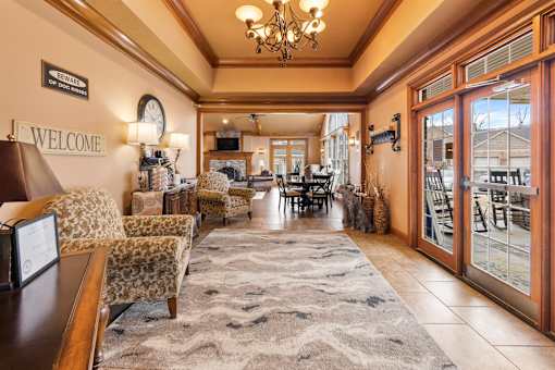A welcoming lobby area with a rug, chairs, and a reception desk.