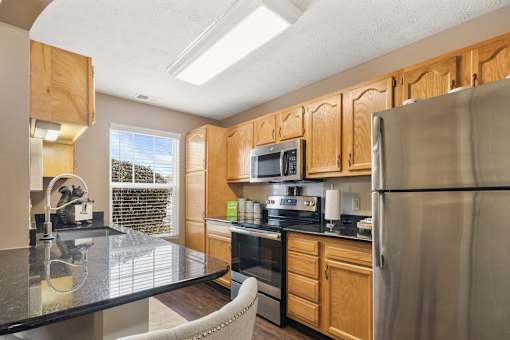 Kitchen with beautiful sunlight at Heritage Trail Apartments in Terre Haute, IN.