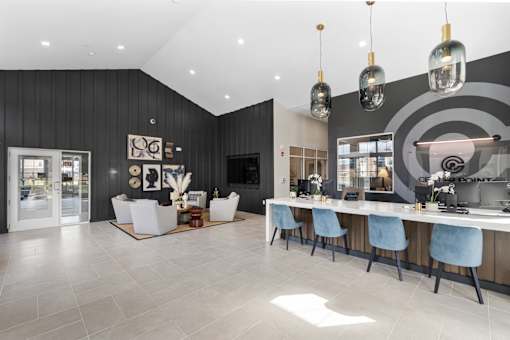 A modern dining room with a long table and chairs.