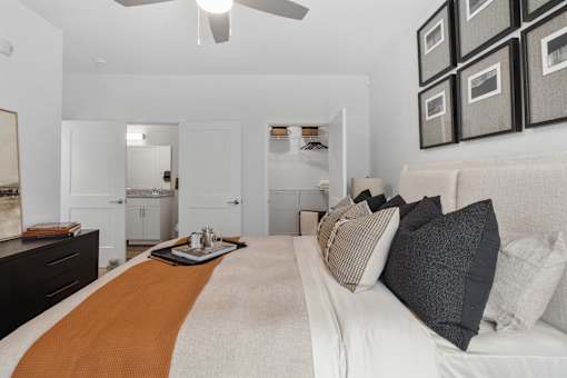 A bedroom with a bed, dresser, and mirror.