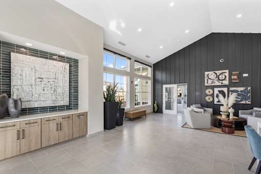 A spacious living room with a large window, a sofa, and a coffee table.