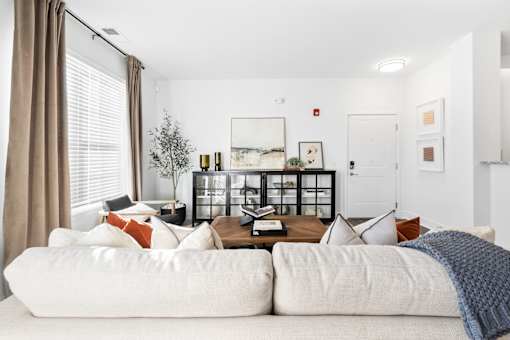 A living room with a white couch and a coffee table.