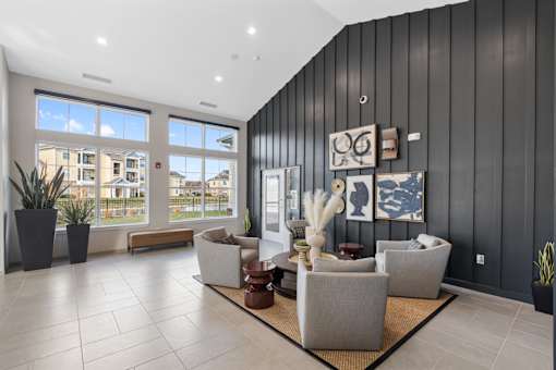 A modern living room with a large window and a view of a residential area.