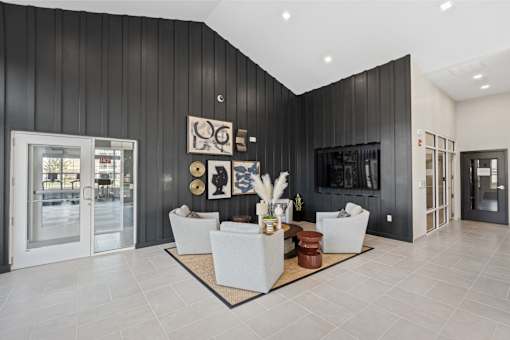 A modern living room with a black wall and a white sofa.
