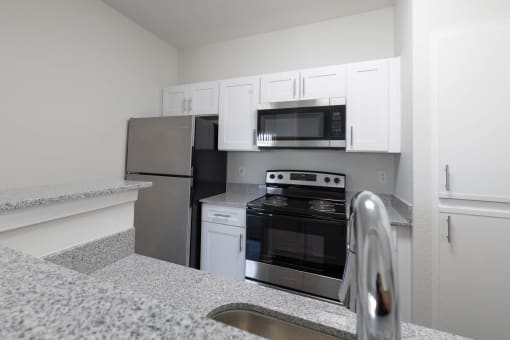 Renovated kitchen featuring appliances at Center Point Apartments, Indianapolis