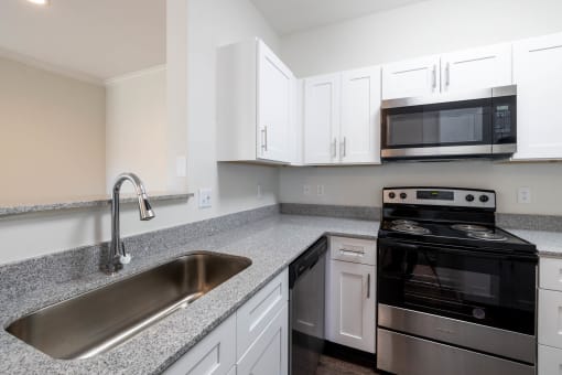 Kitchen featuring black appliances and granite counters at Center Point Apartments, Indianapolis