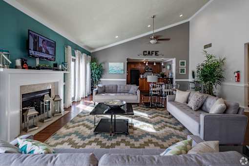 A living room with a fireplace and a couch at Landmark at Lyncrest Reserve Apartments, Tennessee