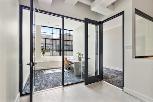Private co-working office with glass doors at Cole Motor in Cole Noble, Indianapolis