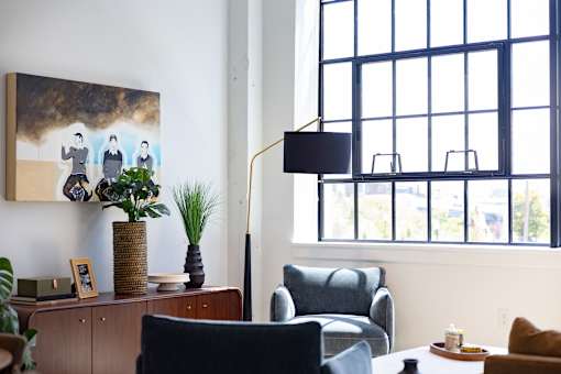 Living room detail with credenza, arc lamp and an original steel window