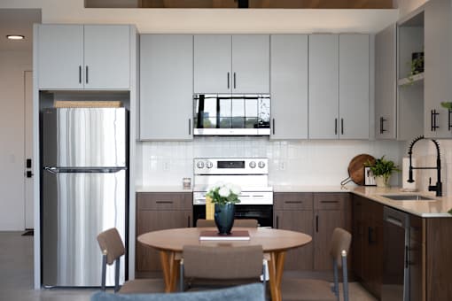 Loft kitchen with stainless refrigerator, range and microwave at Cole Motor