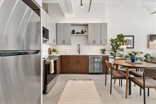 Galley loft kitchen with runner rug and dining area at Cole Motor