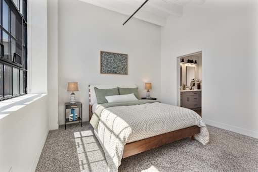 Bedroom with an open door to a private ensuite bathroom