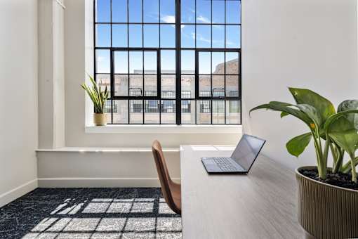 Twelve-foot steel factory window in a private co-working suite at Cole Motor