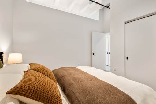 Second bedroom with closet doors and twelve-foot walls