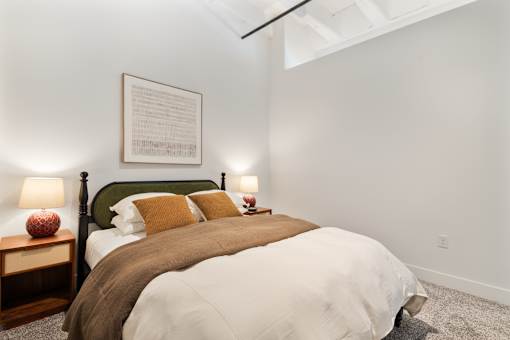 Second bedroom with high ceilings and an exposed structural beam