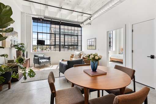 One bedroom loft living and dining area with the bedroom visible beyond