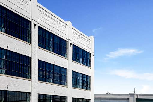 Restored white brick facade and decorative cornice of the 1913 Cole Motor building, Indianapolis 46202