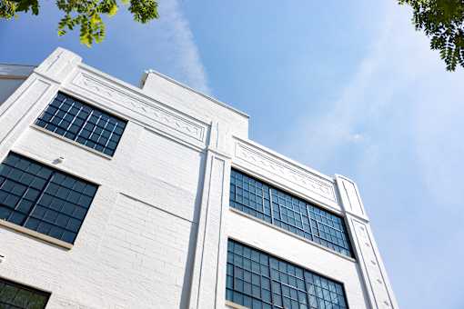 Restored corner facade with decorative brick detail at Cole Motor