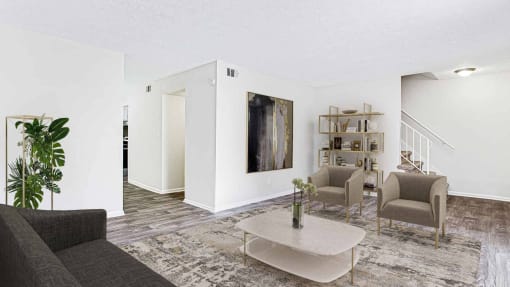a living room with a couch and chairs and a coffee table at Elea Apartments in Marietta, GA