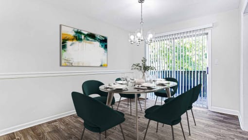 a dining room with a table and chairs at Elea Apartments in Marietta, GA