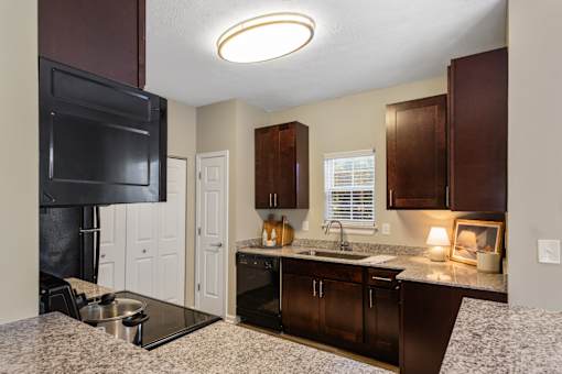 Kitchen with brown cabinets at Fieldstone at Glenwood Crossing, Cincinnati, OH, 45215
