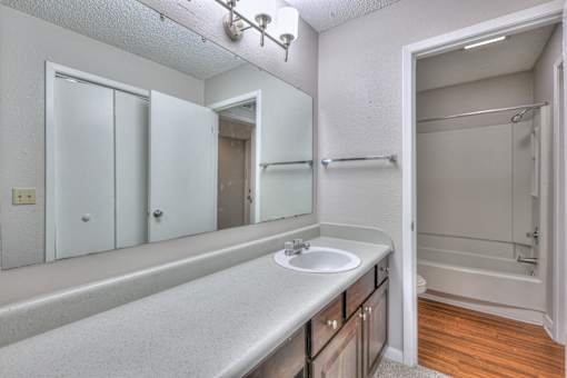 A bathroom with a sink, mirror, and shower at Landmark at Lyncrest Reserve Apartments, Tennessee 37209