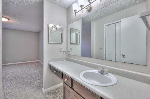 A bathroom with a sink, mirror, and medicine cabinet at Landmark at Lyncrest Reserve Apartments, Tennessee