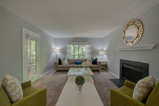 A living room with a fireplace and a mirror on the wall.