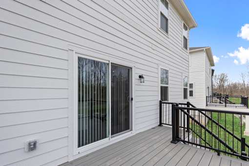 Rear view of two-story single-family rental home with backyard space at Mural Lewis Center in Lewis Center, Ohio