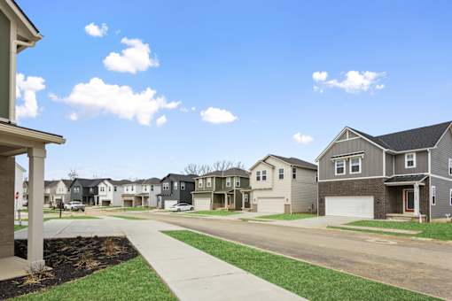 Row of modern single-family rental homes with sidewalks and varied exterior styles at Mural Lewis Center