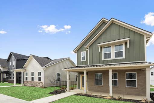 Front exterior of two-story single-family rental home with modern siding at Mural Lewis Center in Lewis Center, Ohio