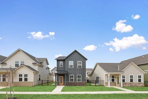 Two-story home with attached garage and driveway at Mural Lewis Center in Lewis Center, Ohio