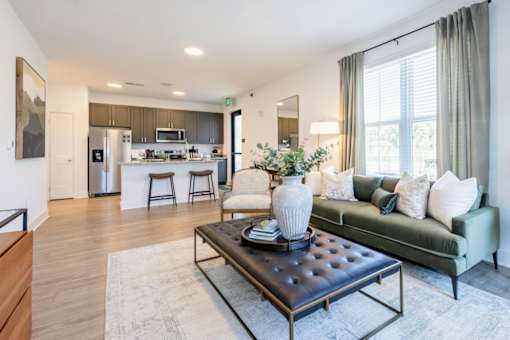 Apartment living room with stylish furniture and view of open kitchen at Nook Nine