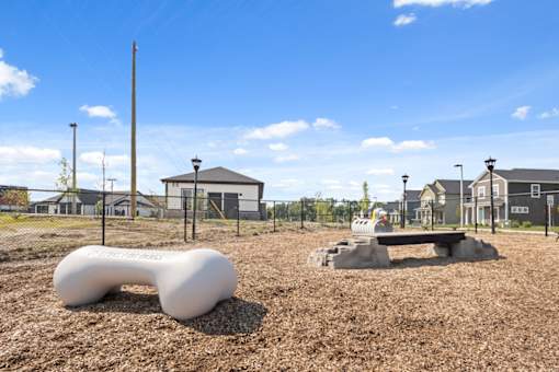 A playground with a white slide and a bench.