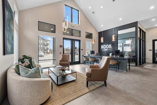 Stylish leasing office at Nook Nine with modern seating, high ceilings, and warm natural light.