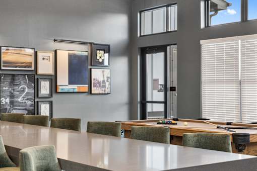 Clubhouse at Nook Nine with a billiards table, modern artwork, and a sleek communal table.