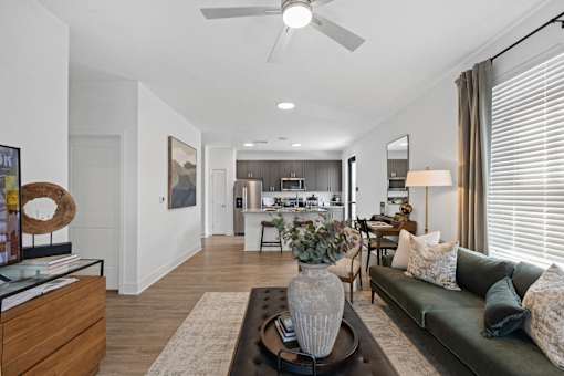 Open-concept living at Nook Nine with a stylish living room, modern kitchen, and wood-style flooring.