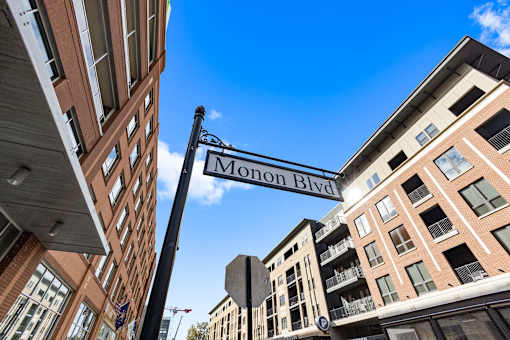 a street sign for monon blvd between two buildings at Gramercy Apartments, Carmel, IN 46032