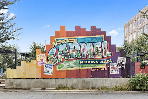 a large mural on the side of a building that reads carmel midtown plaza at Gramercy Apartments, Carmel