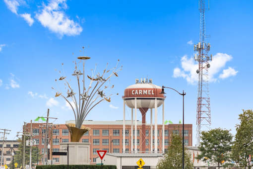a water tower on top of a building in front of a hospital at Gramercy Apartments, Carmel, IN