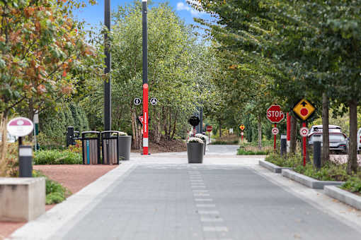 a city sidewalk with trees and a stop sign at Gramercy Apartments, Carmel, 46032