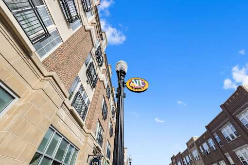 a sign on a pole in front of a building at Gramercy Apartments, Carmel